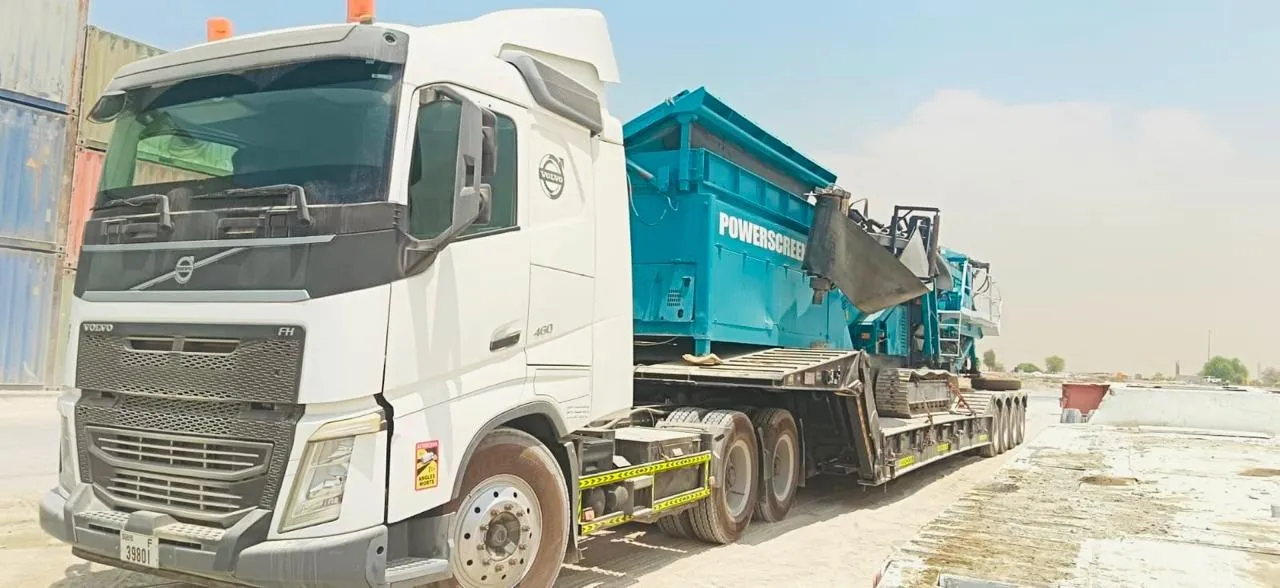 Volvo FH 460 prime mover transporting a Powerscreen crushing and screening plant on a lowbed trailer