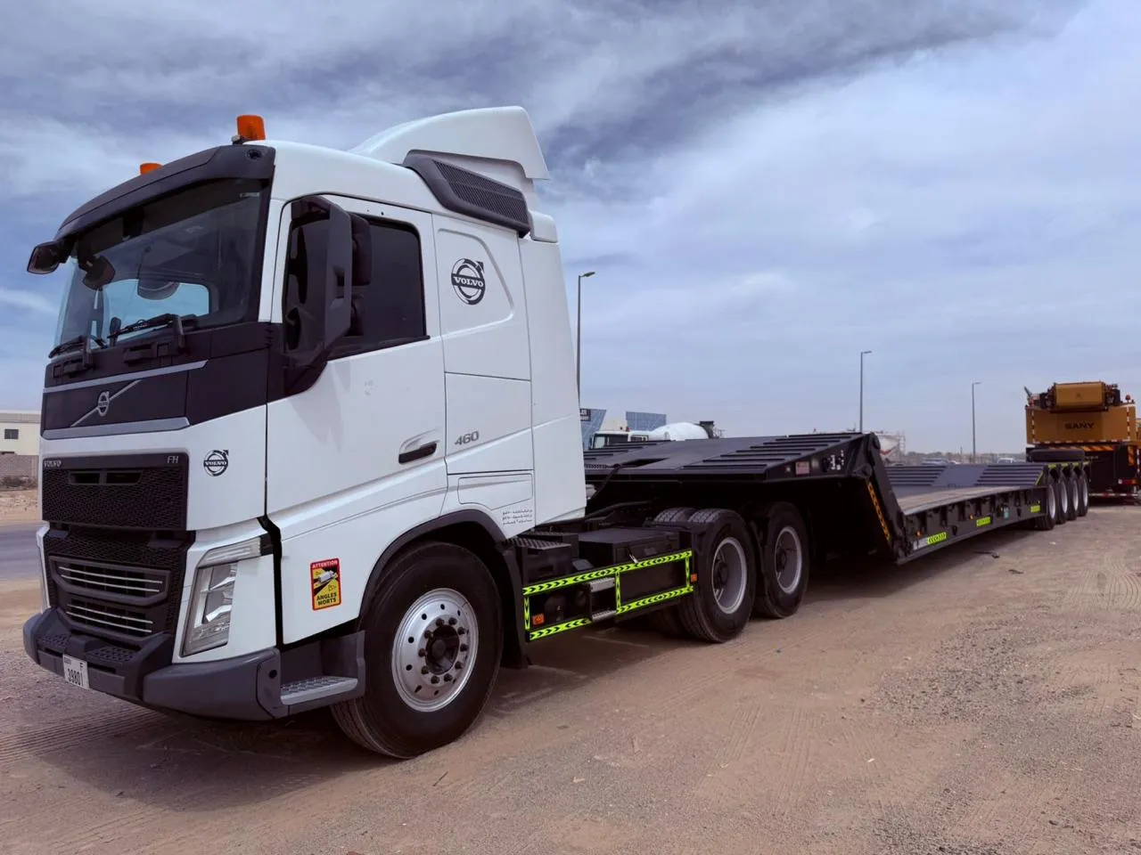 Volvo FH 460 prime mover with hydraulic low-bed trailer in the equipment yard